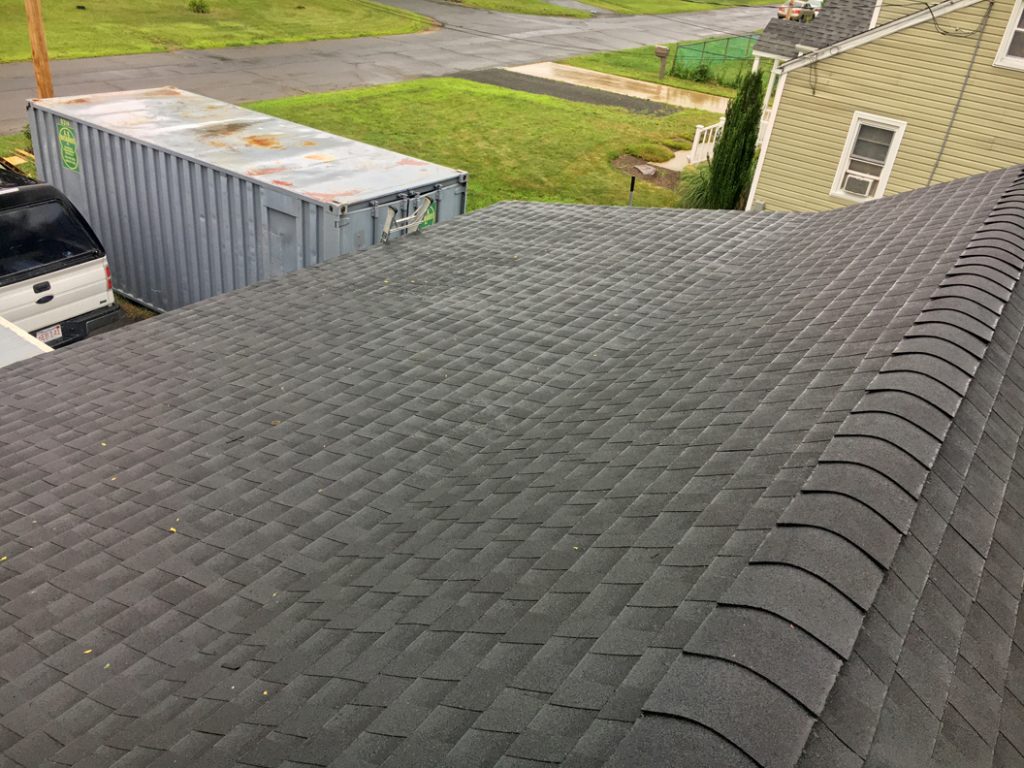Finished asphalt shingling over the garage showing the dual pitch roof