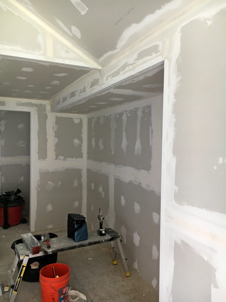 The drywall being taped and mudded