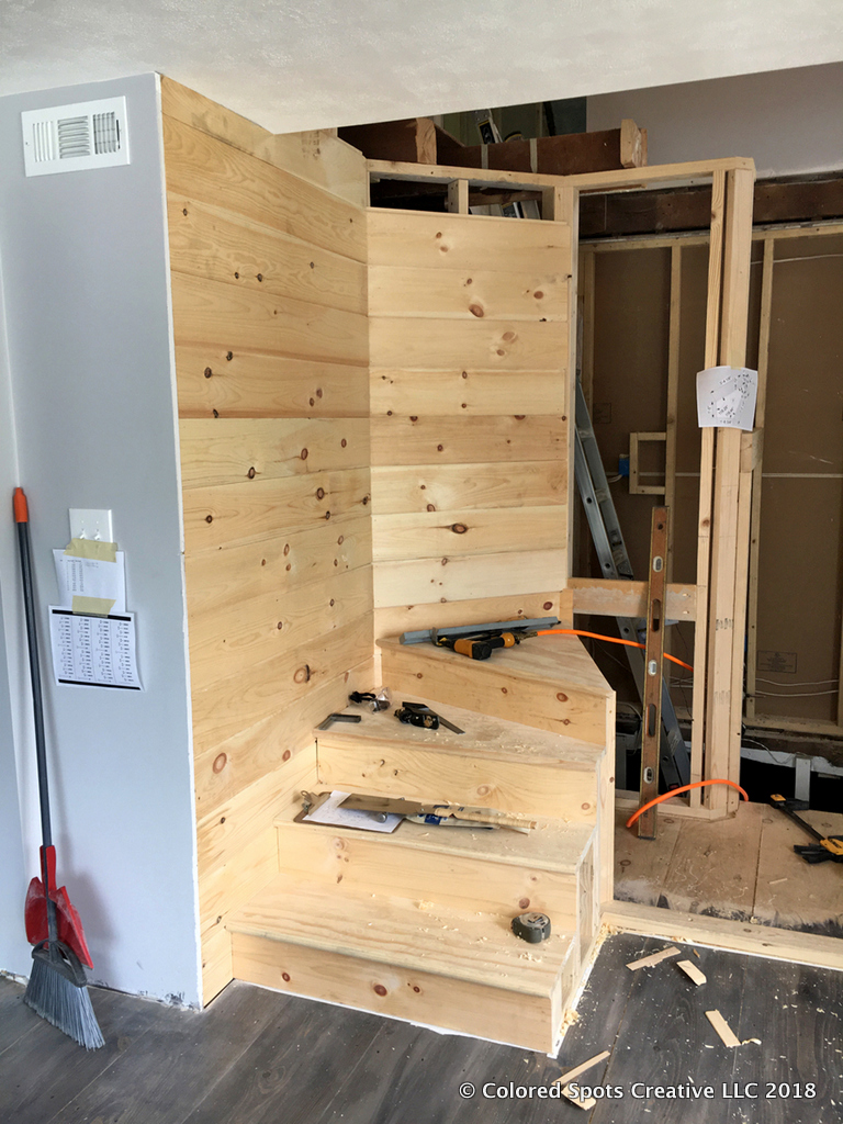 Paneling the staircase support wall with v-groove pine