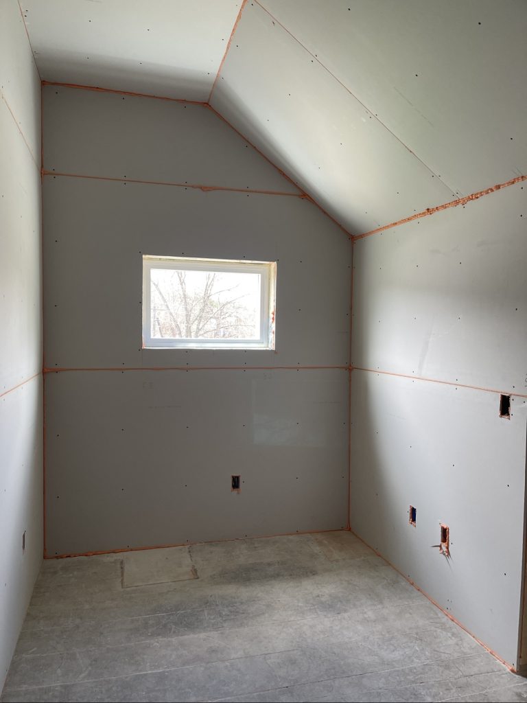 Drywall installed in the office looking at the window