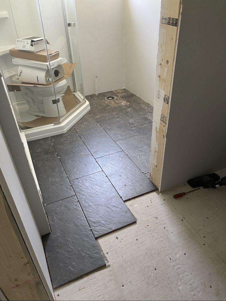 Installing tiles from the bathroom into the Laundry Room